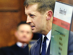 Walter McKee in the courtroom holding up an infographic with a Judge in the background